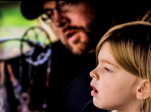 young girl watches nature from ground blind with father - copyright andrewbrown